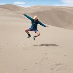Joyful movement in the desert dunes — embodying the freedom, agility, and recreating with skill gained through therapeutic massage and movement